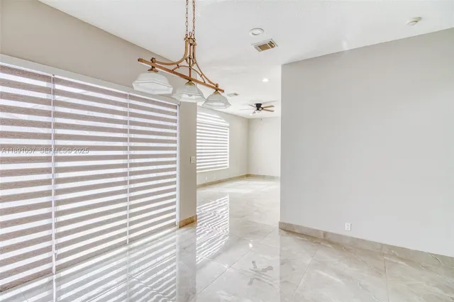 a kitchen with white cabinets and appliances