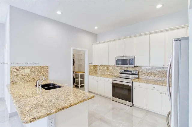 a kitchen with a refrigerator stove and microwave