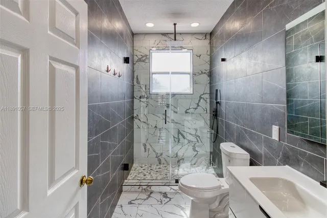 a view of a hallway with a window and a chandelier fan