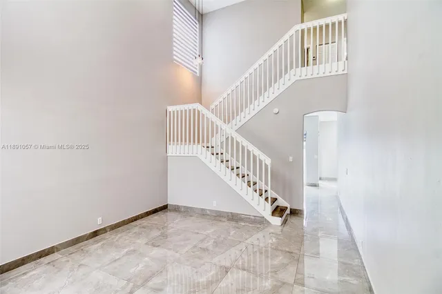 a view of staircase with white walls and a window