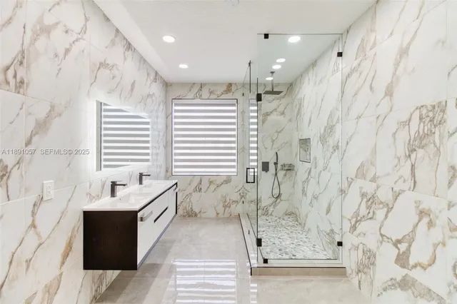 a front view of a house with a yard and potted plants