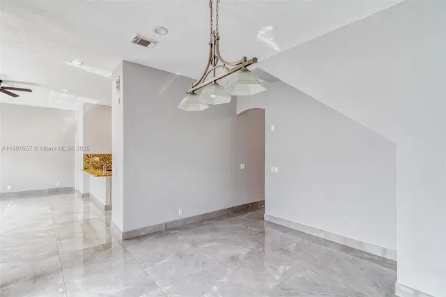 a view of a chandelier fan in a room