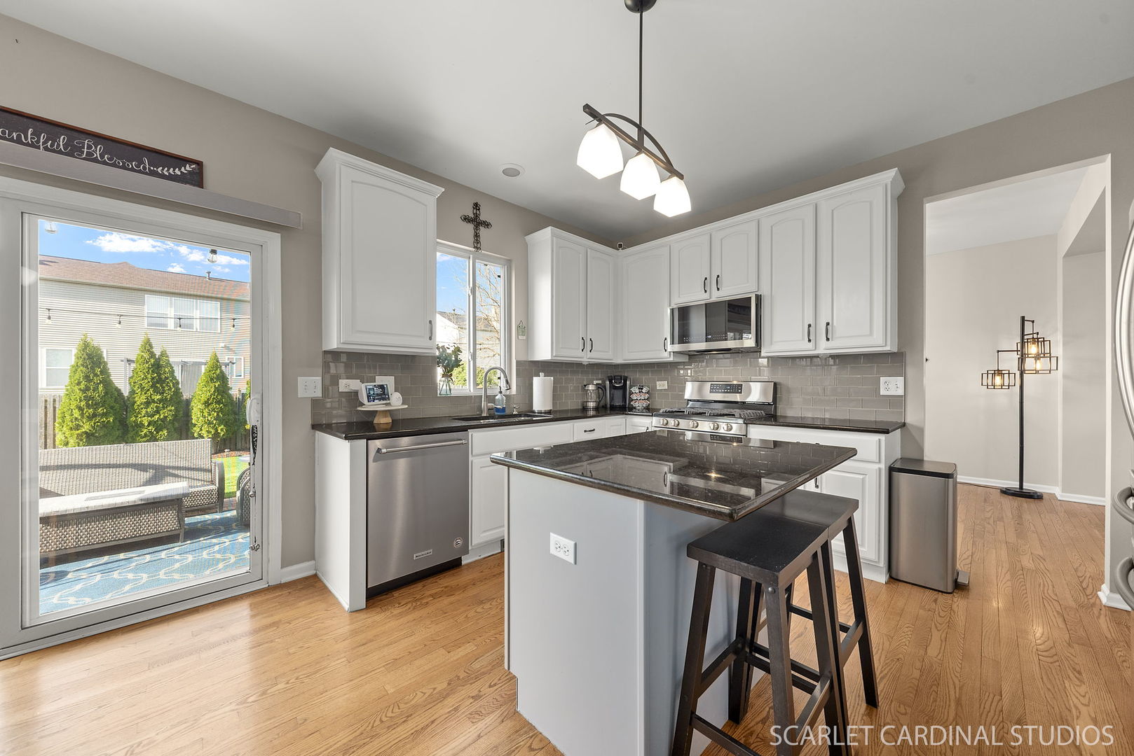 11748 Glenn Circle Plainfield, IL 60585 - Photo 5 of 24 a kitchen with stainless steel appliances granite countertop a stove top oven a sink a refrigerator and white cabinets