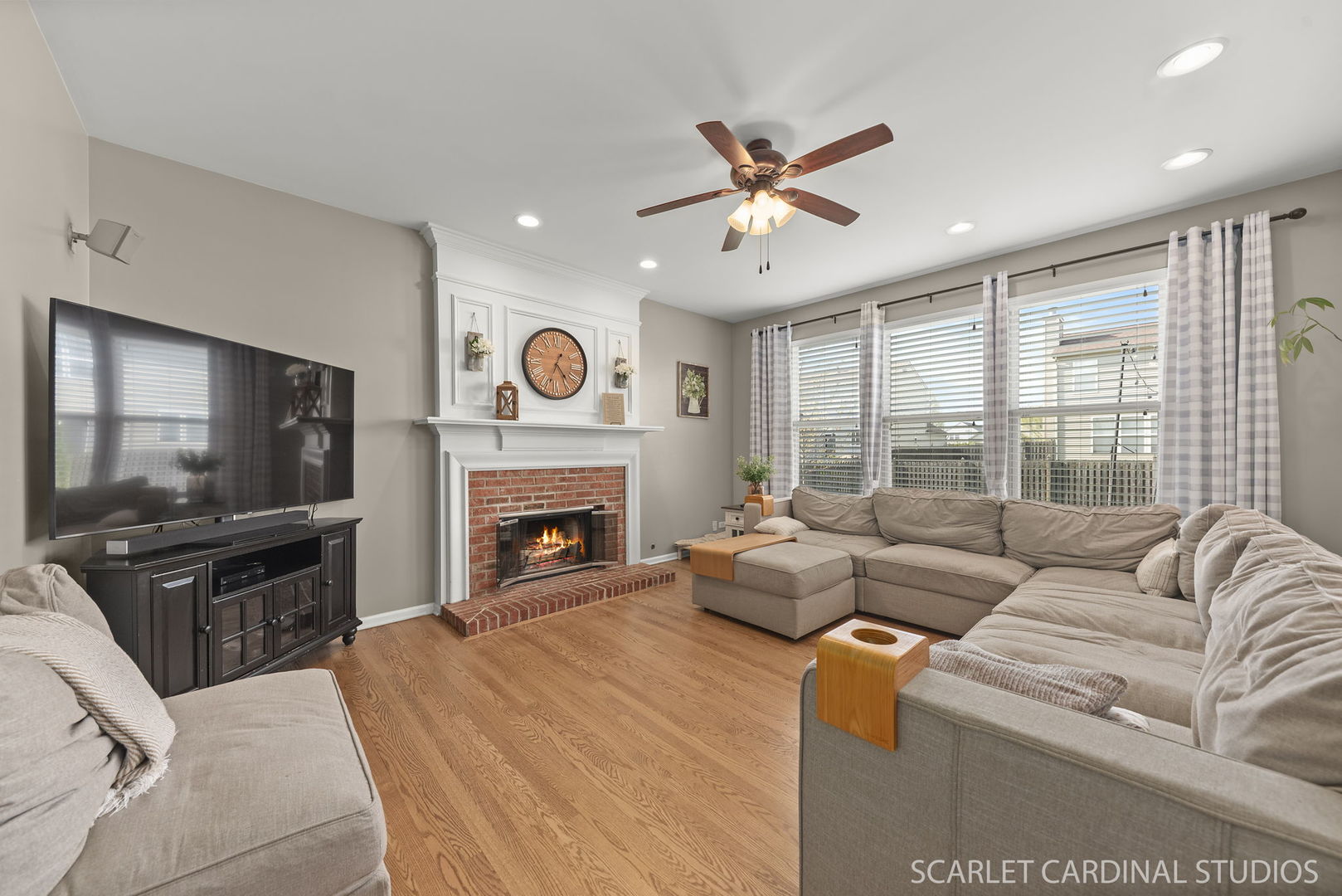 11748 Glenn Circle Plainfield, IL 60585 - Photo 7 of 24 a living room with furniture a flat screen tv and a fireplace