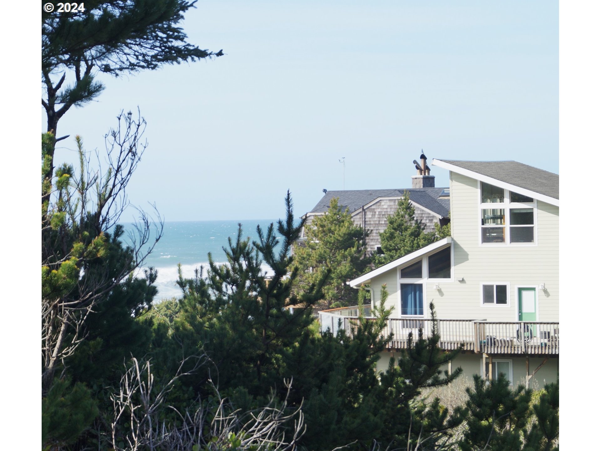 6400 Division Street Depoe Bay, OR 97341 - Photo 3 of 6 a house with trees in front of it