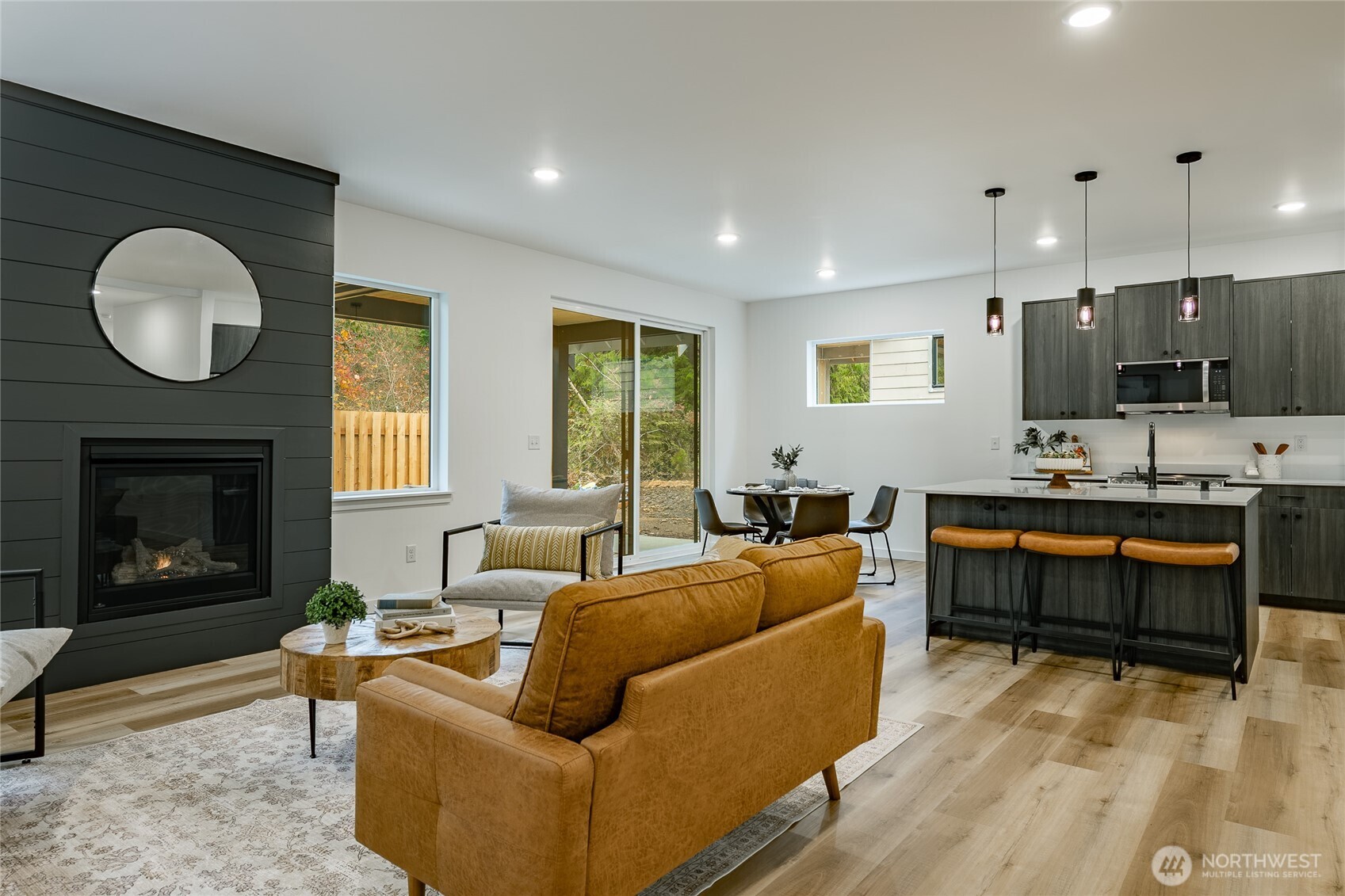 2992 Cedar View Road Blaine, WA 98230 - Photo 13 of 39 a living room with furniture a fireplace a flat screen tv and a large window