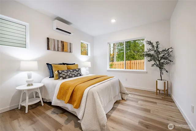 a bedroom with a bed and a potted plant