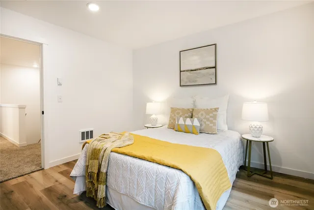 a bedroom with a bed and a lamp on table