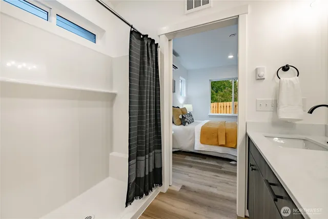 a bathroom with a tub sink and shower