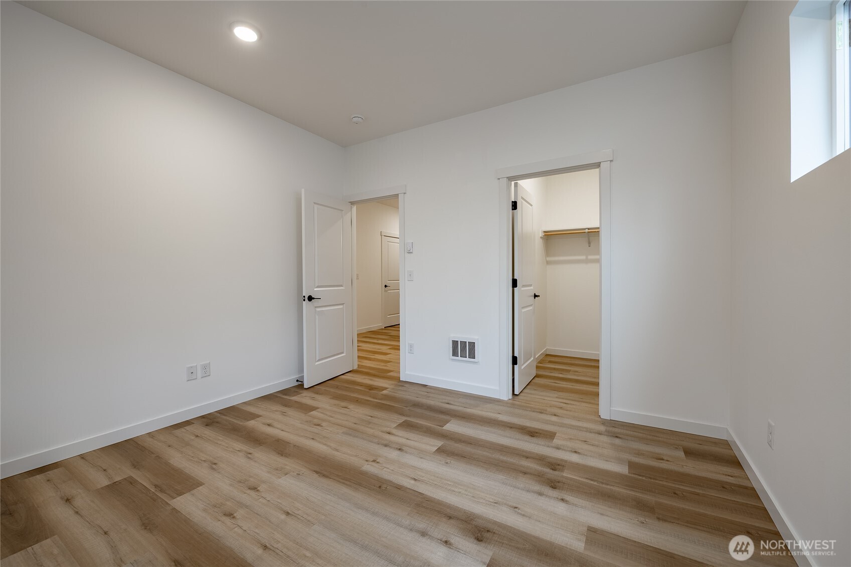 2992 Cedar View Road Blaine, WA 98230 - Photo 27 of 39 an empty room with wooden floor and windows
