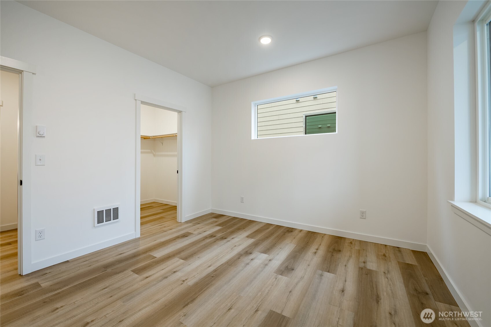 2992 Cedar View Road Blaine, WA 98230 - Photo 28 of 39 an empty room with wooden floor and windows