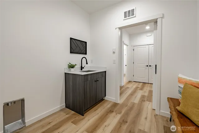 a spacious bathroom with a sink and mirror
