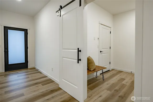 a view of a livingroom with wooden floor and a staircase