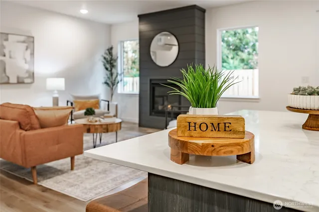a living room with furniture flowerpot and a window