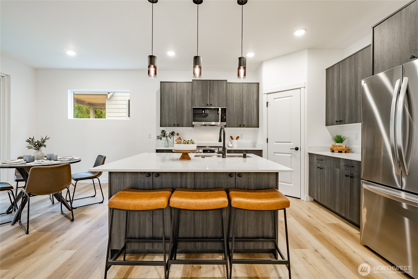2992 Cedar View Road Blaine, WA 98230 - Photo 10 of 39 a kitchen with stainless steel appliances granite countertop a kitchen island a table and chairs in it