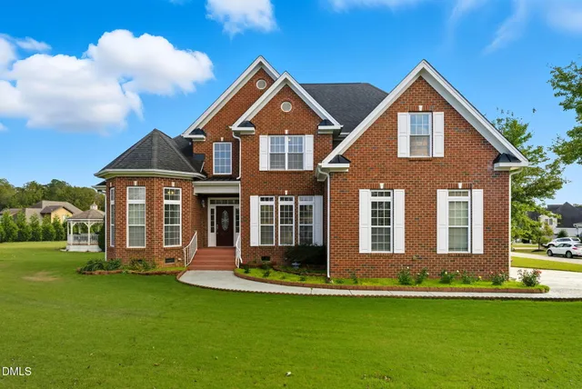 a front view of a house with a yard and garage