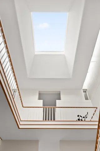 a bathroom with a sink a light fixture and a toilet