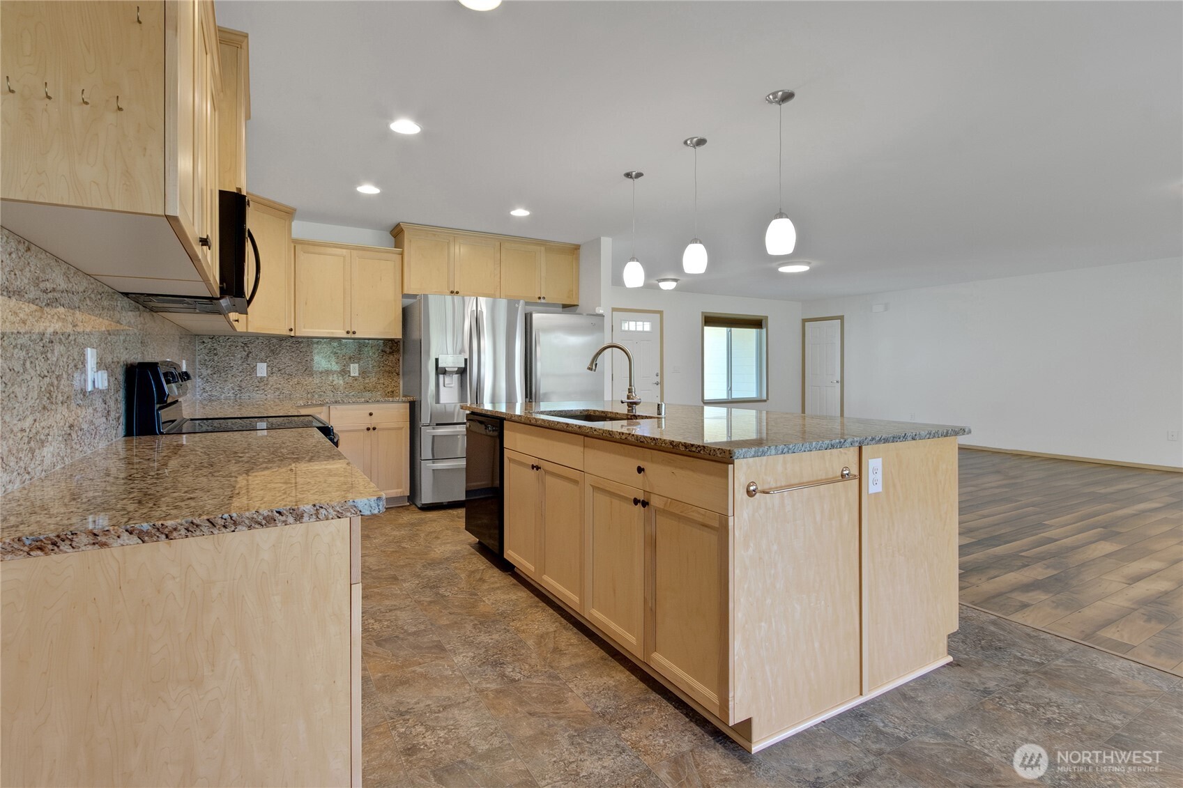 1450 Southeast Spruce Road Port Orchard, WA 98367 - Photo 4 of 39 a large kitchen with stainless steel appliances granite countertop a large counter top a stove and a sink