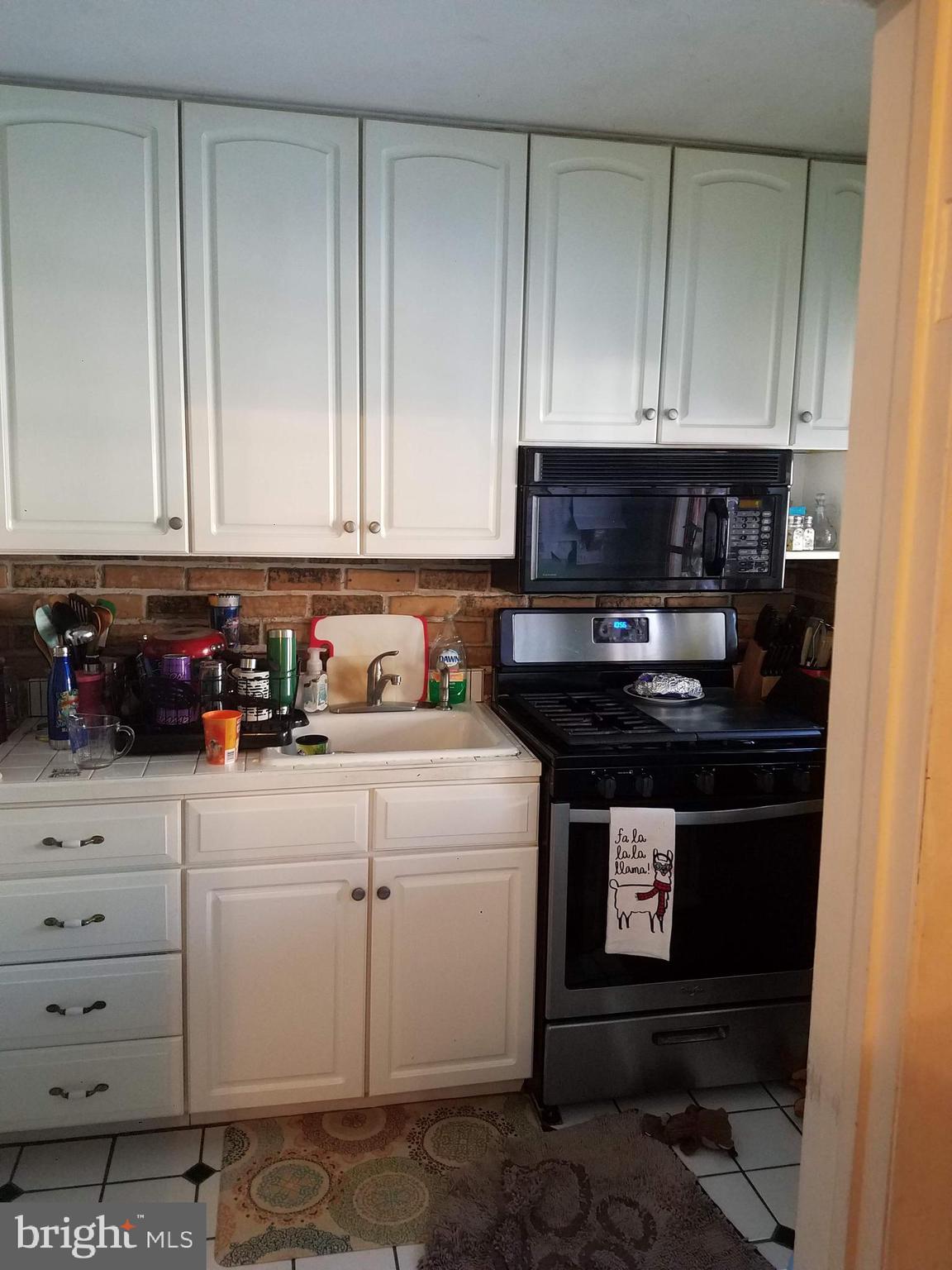 1710 Pin Oak Road Baltimore, MD 21234 - Photo 3 of 5 a kitchen with stainless steel appliances granite countertop a stove a microwave and cabinets