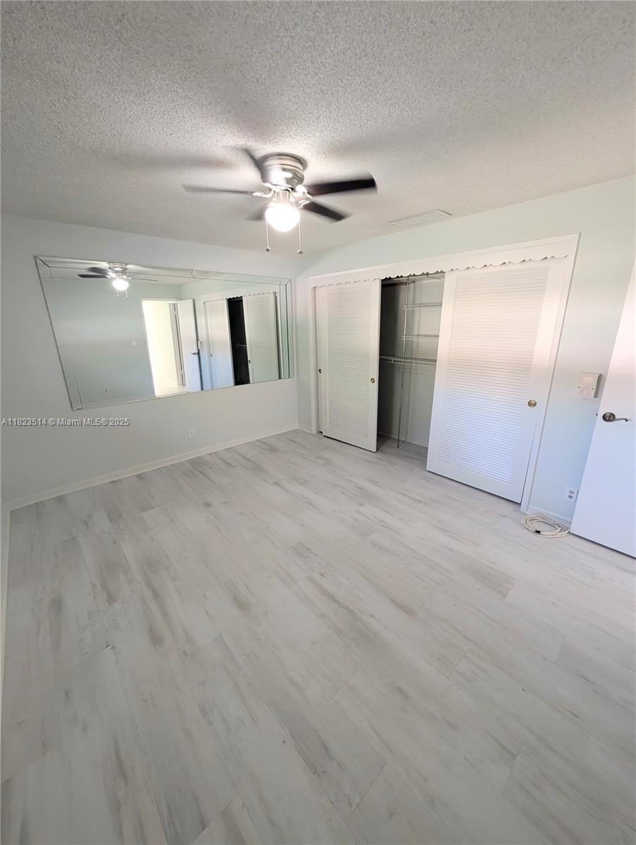 14901 Southwest 4th Street, Unit 9A Pembroke Pines, FL 33027 - Photo 12 of 35 en empty room with windows and fan