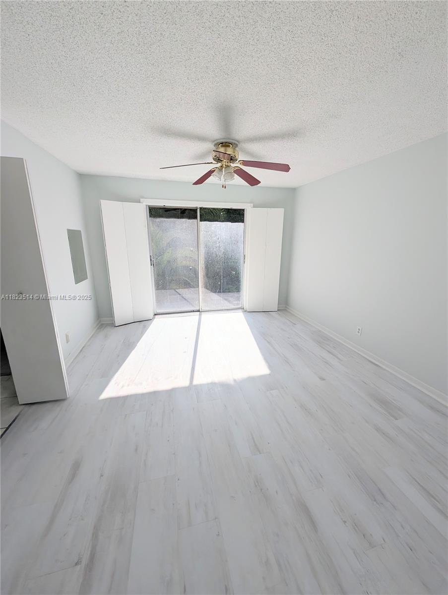 14901 Southwest 4th Street, Unit 9A Pembroke Pines, FL 33027 - Photo 14 of 35 an empty room with wooden floor and windows