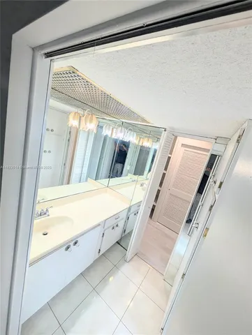 a bathroom with a granite countertop shower and a toilet