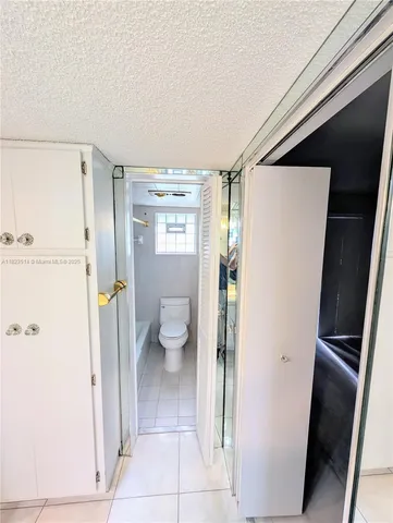 a bathroom with a glass shower door and a sink