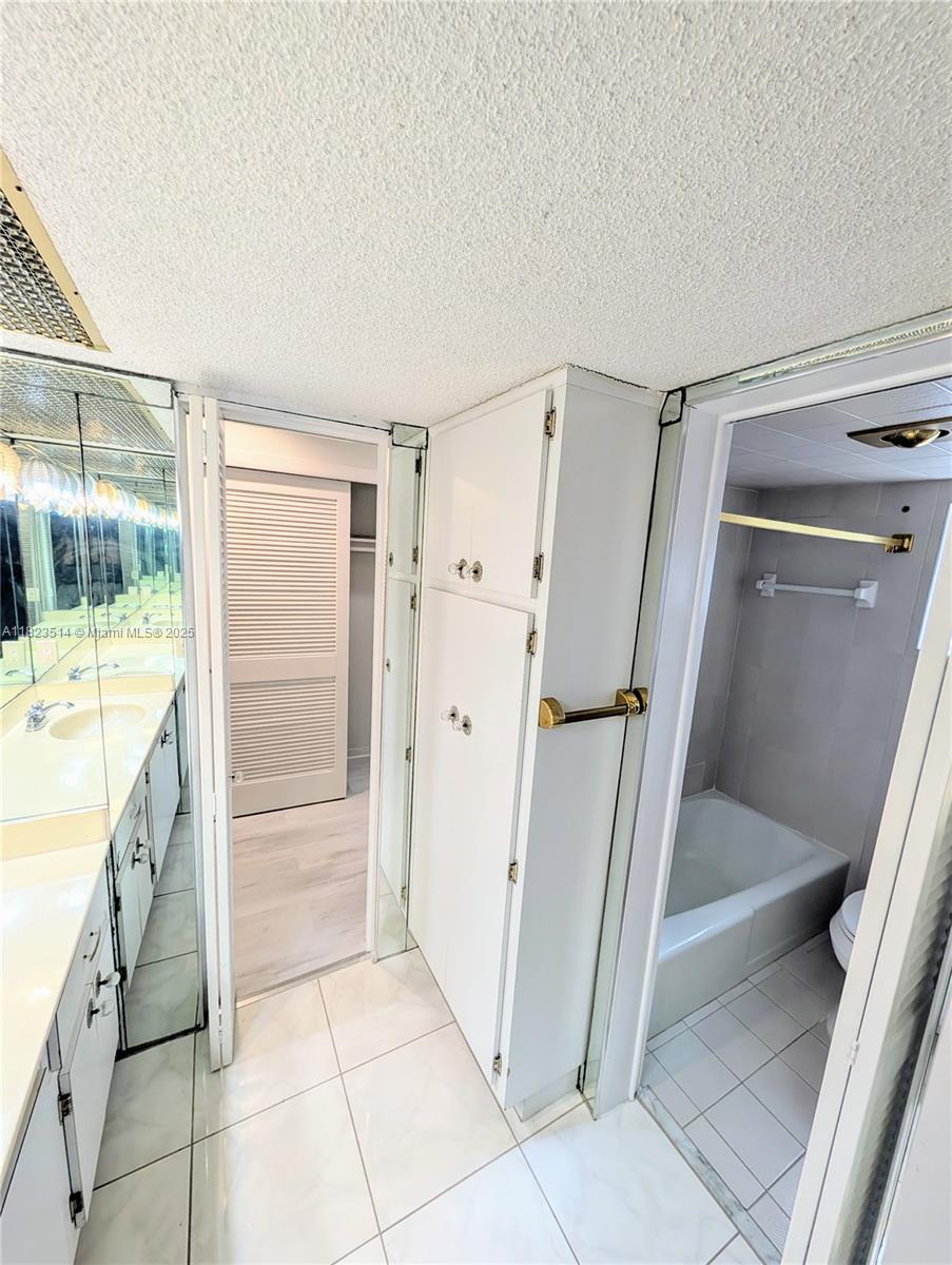 14901 Southwest 4th Street, Unit 9A Pembroke Pines, FL 33027 - Photo 20 of 35 a bathroom with a glass shower door and a sink