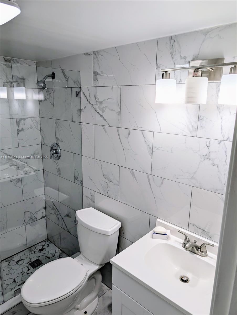 14901 Southwest 4th Street, Unit 9A Pembroke Pines, FL 33027 - Photo 25 of 35 a bathroom with a toilet sink and shower