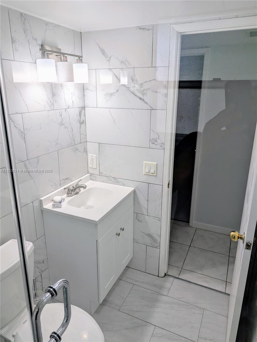 14901 Southwest 4th Street, Unit 9A Pembroke Pines, FL 33027 - Photo 26 of 35 a bathroom with a sink toilet and shower