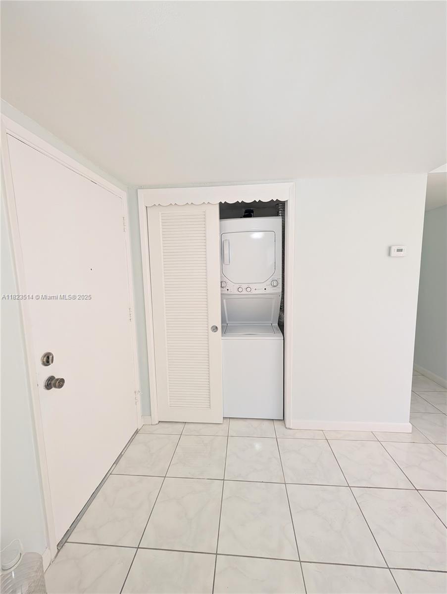 14901 Southwest 4th Street, Unit 9A Pembroke Pines, FL 33027 - Photo 27 of 35 a view of a refrigerator in kitchen and white cabinets