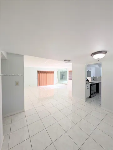 a view of a house with a yard and potted plants