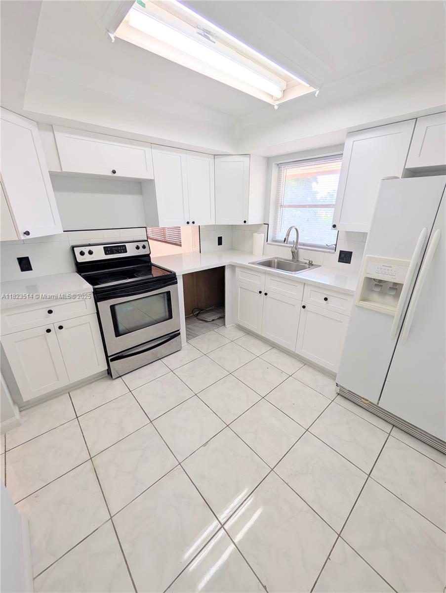 14901 Southwest 4th Street, Unit 9A Pembroke Pines, FL 33027 - Photo 3 of 35 a kitchen with a stove a sink and a refrigerator