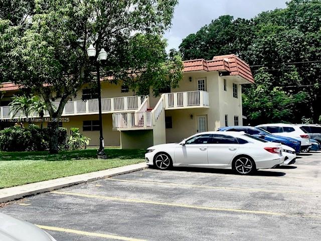 14901 Southwest 4th Street, Unit 9A Pembroke Pines, FL 33027 - Photo 34 of 35 a white car parked in front of a house