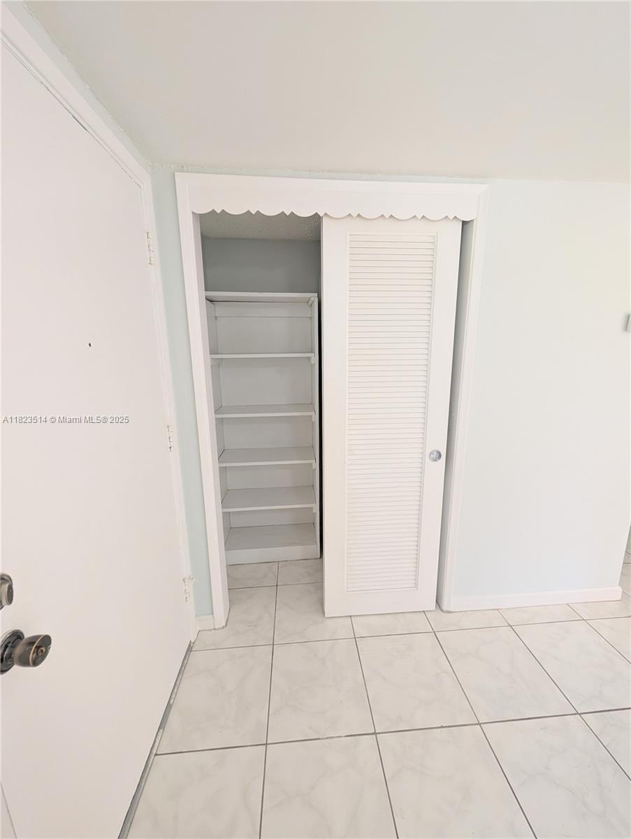 14901 Southwest 4th Street, Unit 9A Pembroke Pines, FL 33027 - Photo 4 of 35 a view of walk in closet with empty racks