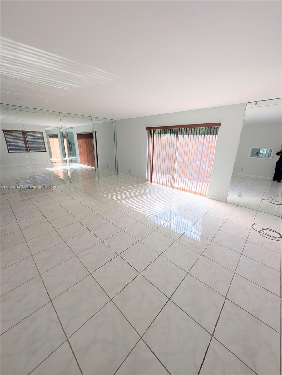 14901 Southwest 4th Street, Unit 9A Pembroke Pines, FL 33027 - Photo 6 of 35 a view of an empty room with a window