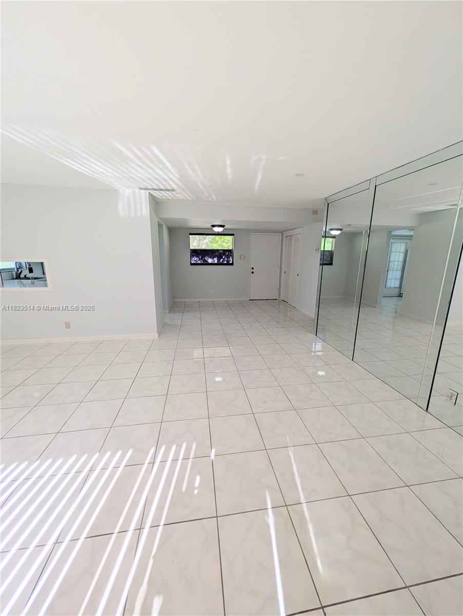 14901 Southwest 4th Street, Unit 9A Pembroke Pines, FL 33027 - Photo 8 of 35 a view of a livingroom with an empty space and a sink
