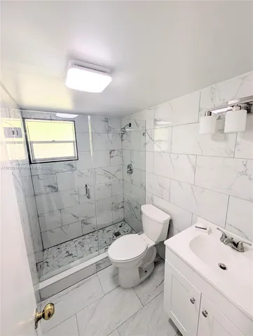 a bathroom with a toilet sink and shower