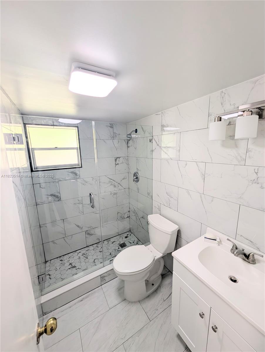 14901 Southwest 4th Street, Unit 9A Pembroke Pines, FL 33027 - Photo 10 of 35 a bathroom with a toilet sink and shower