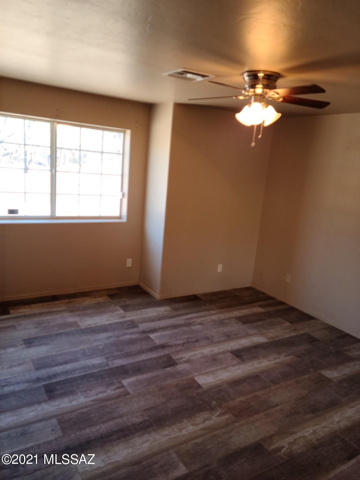 1038 Oso Court Rio Rico, AZ 85648 - Photo 31 of 50 a view of a room with wooden floor and a window