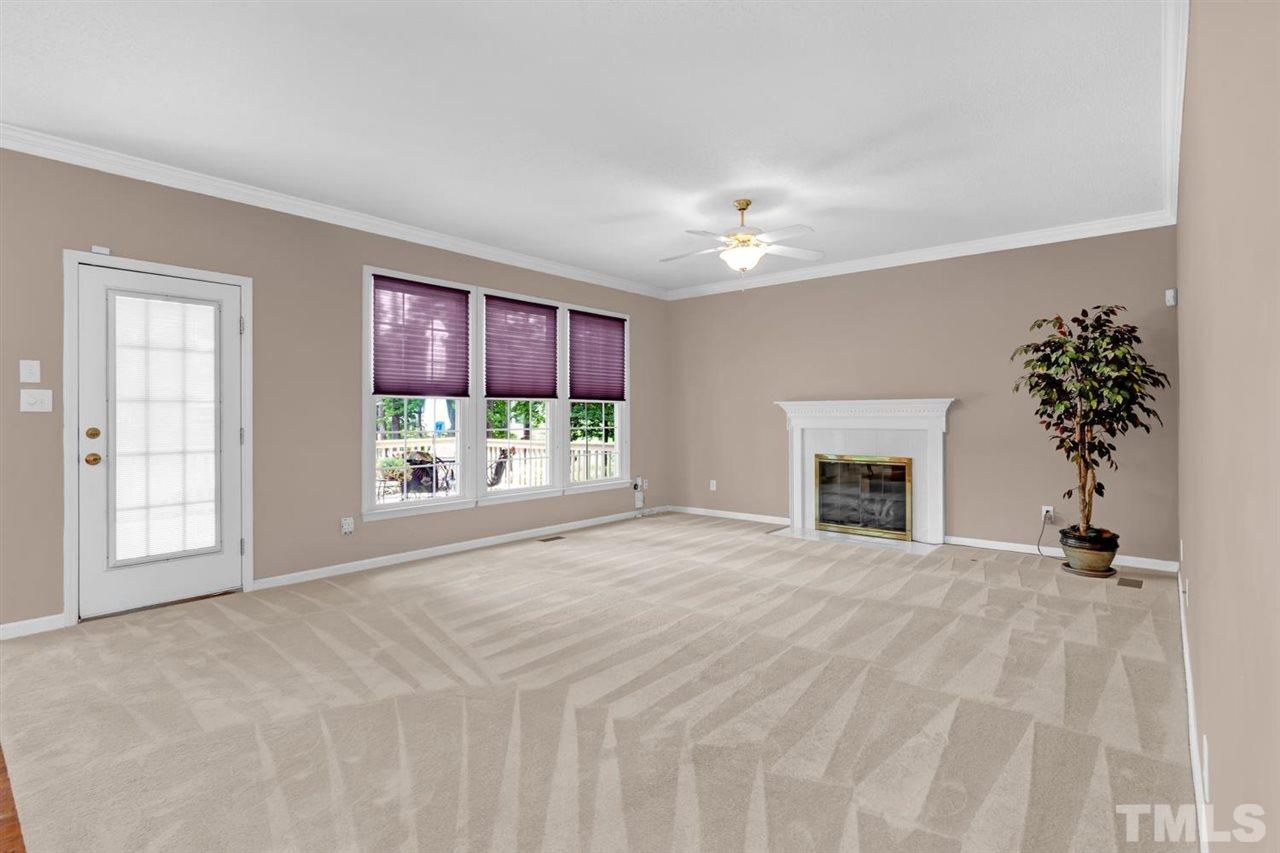 8601 Wheeling Drive Raleigh, NC 27615 - Photo 16 of 25 a view of an empty room with a fireplace and a window