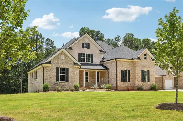 a front view of a house with a yard