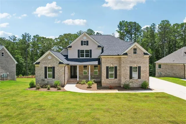 an aerial view of a house with a yard basket ball court and outdoor seating