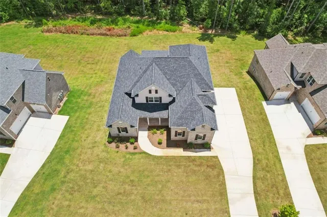 an aerial view of a house with a yard