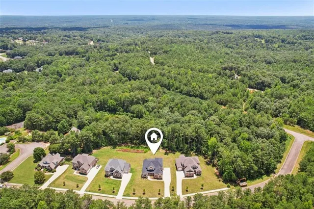 an aerial view of residential house with pool and yard