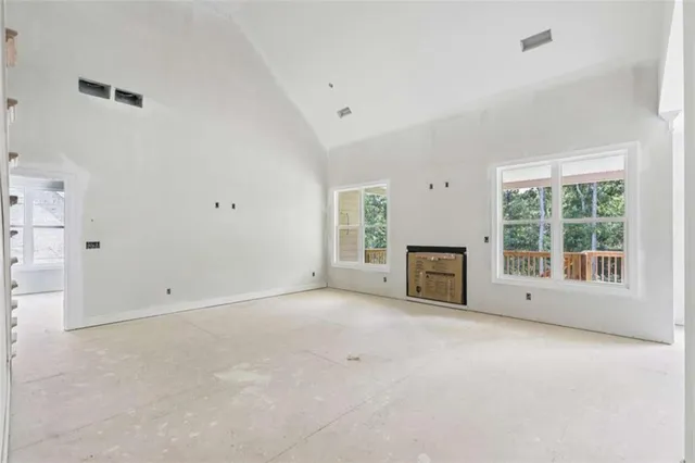 a view of empty room with a fireplace