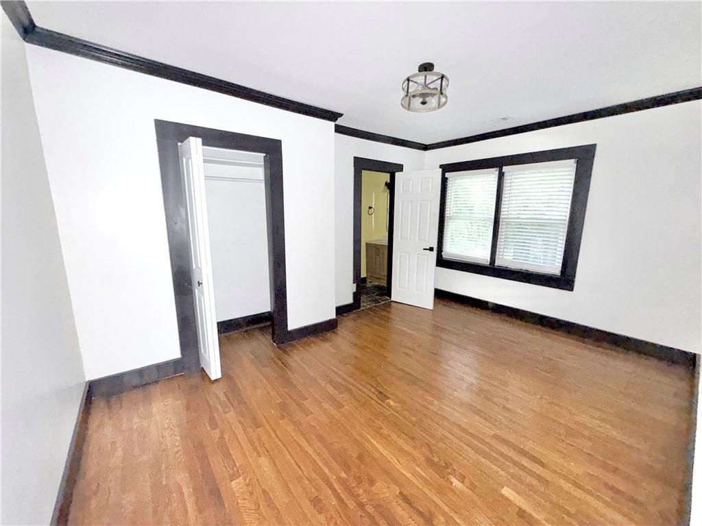 1802 South Gordon Street Southwest Atlanta, GA 30310 - Photo 11 of 14 an empty room with wooden floor and windows