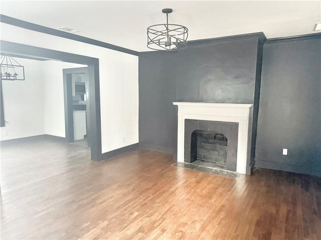 1802 South Gordon Street Southwest Atlanta, GA 30310 - Photo 2 of 14 a view of a livingroom with wooden floor and a fireplace