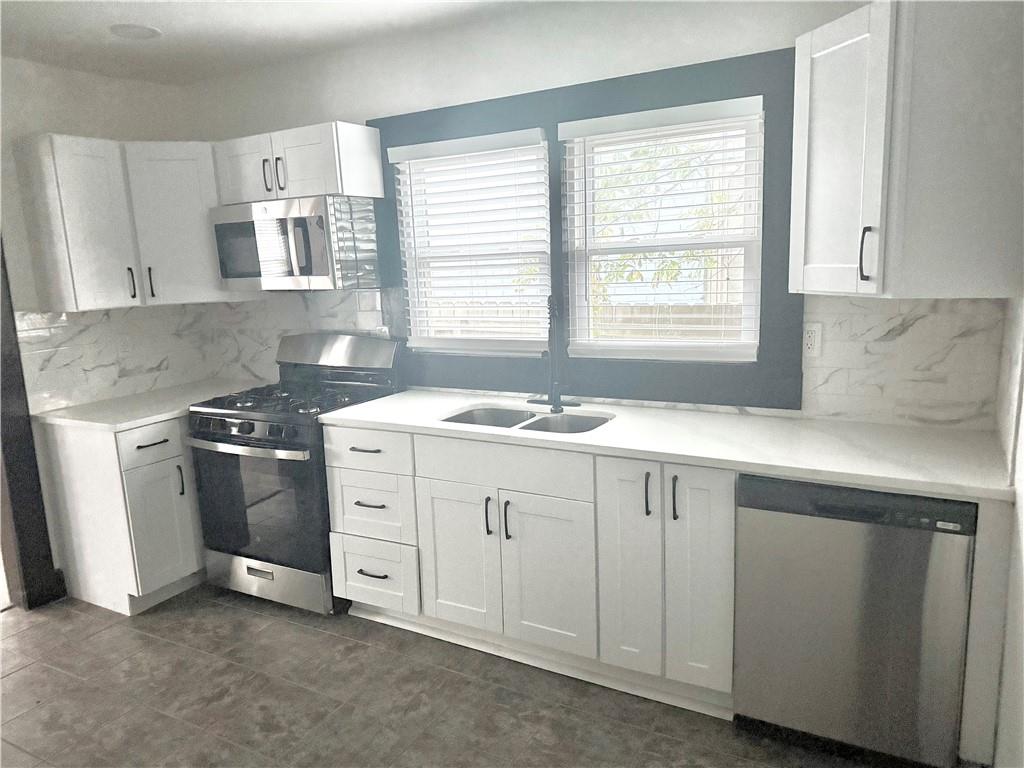 1802 South Gordon Street Southwest Atlanta, GA 30310 - Photo 4 of 14 a kitchen with granite countertop white cabinets and a sink