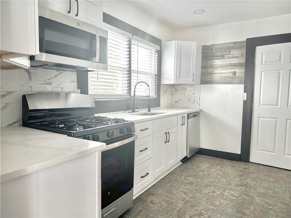 1802 South Gordon Street Southwest Atlanta, GA 30310 - Photo 5 of 14 a kitchen with a stove oven and white cabinets